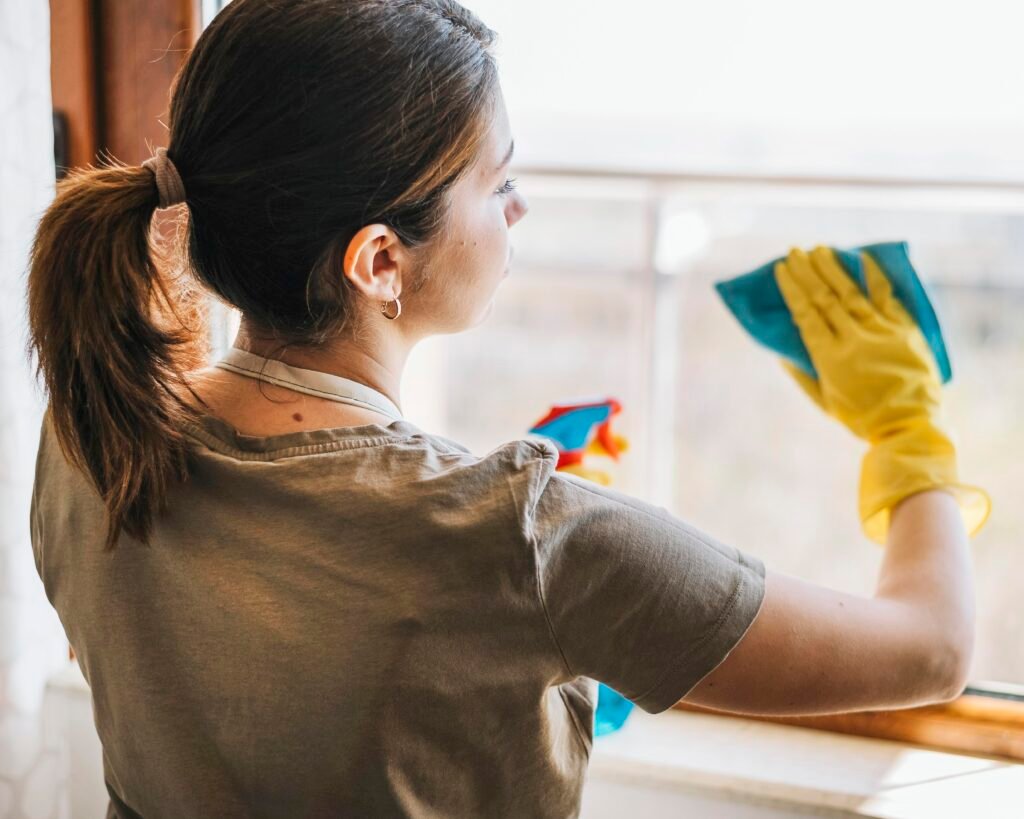 medium-shot-woman-cleaning-window